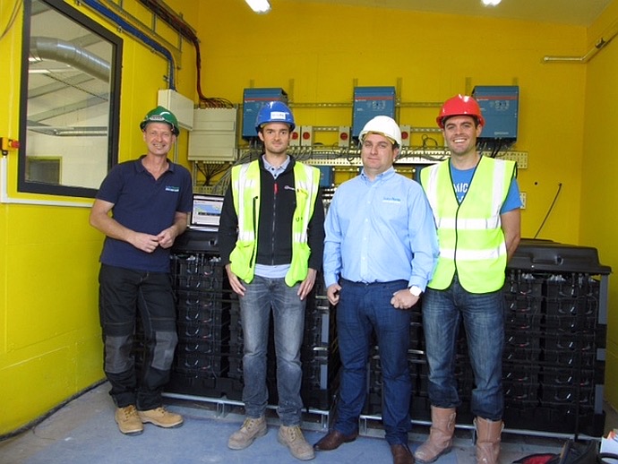 Ian Hewson with the project team beside the Active Classroom saltwater battery energy storage system